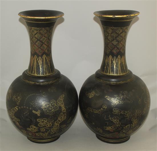 A pair of Chinese gilt and polychrome decorated black lacquer bottle vases, early 20th century, 44cm